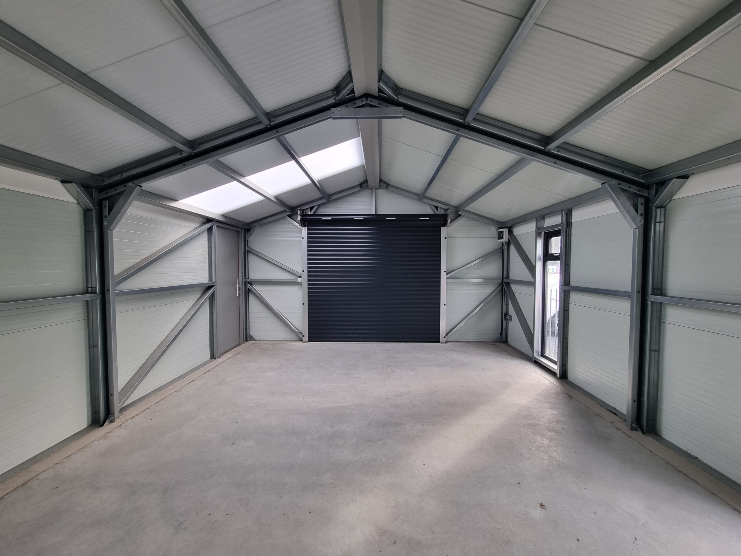Interior of our Gold Range Garage showing an added electric roller door which is an optional upgrade.