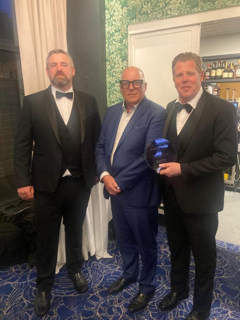 Darren and Thomas Keoghan, owners of Irish steel company Shanette Superior Space, standing with architect and TV personality Hugh Wallace at the Midlands 103 Customer Service Awards 2025.